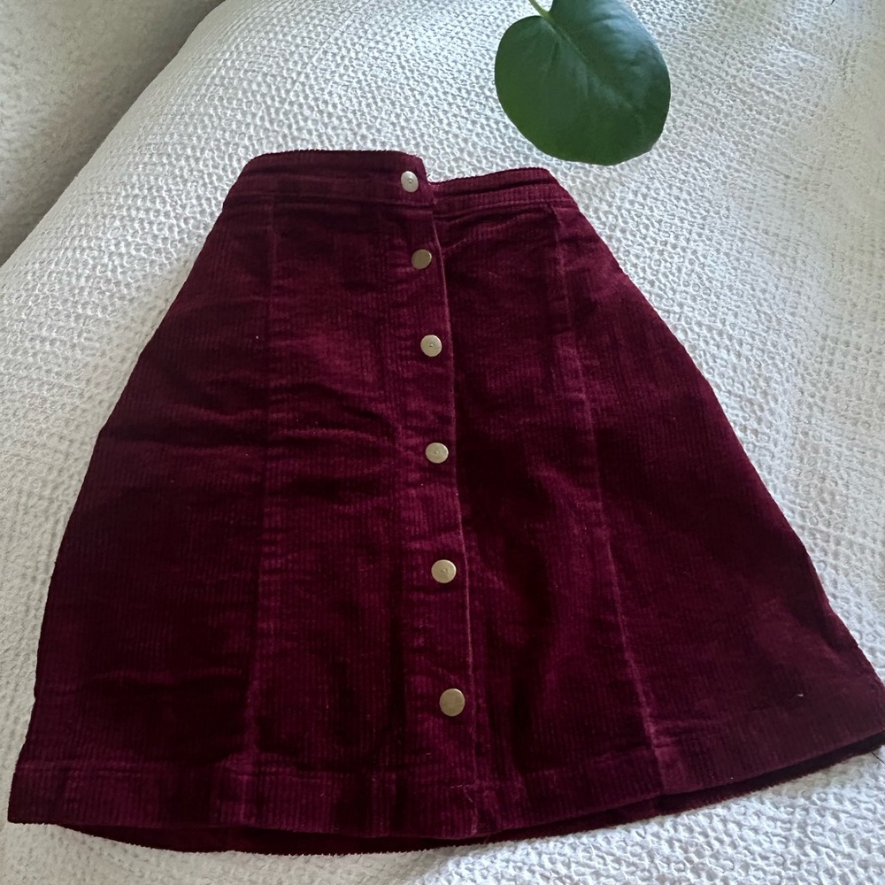 Rich, crimson red, velvet skirt, with pop buttons down the middle.